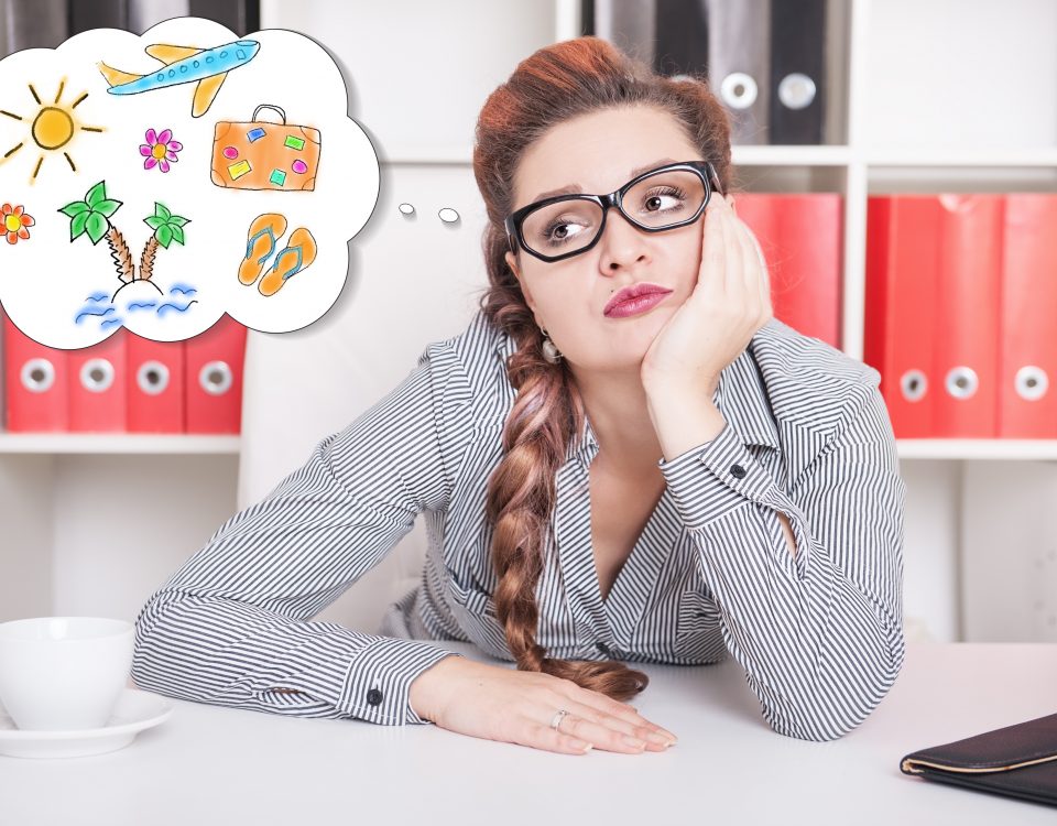 woman day dreaming of a holiday vacation while at work | Sell your jewellery at Post My Gold