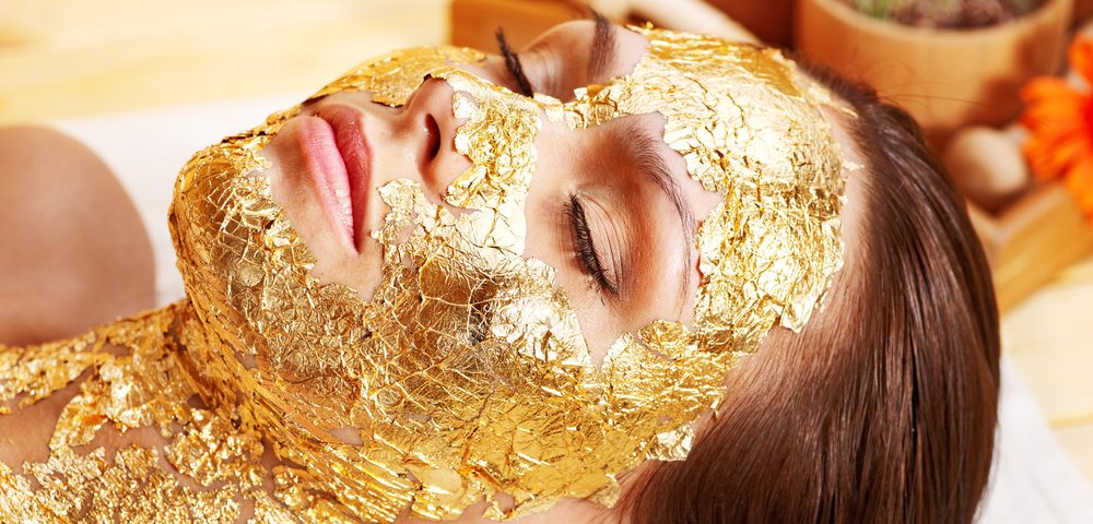 Gold for cash -Woman having a gold facial