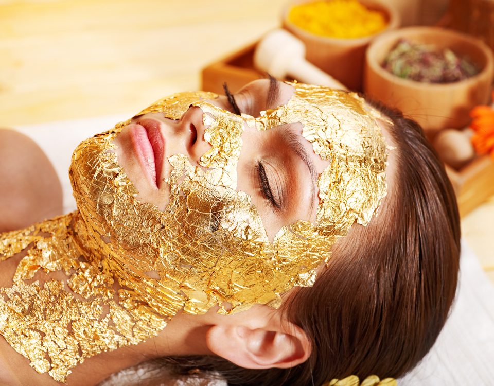 Gold for cash -Woman having a gold facial