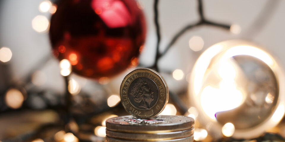a pile of cash with jewellery in the background