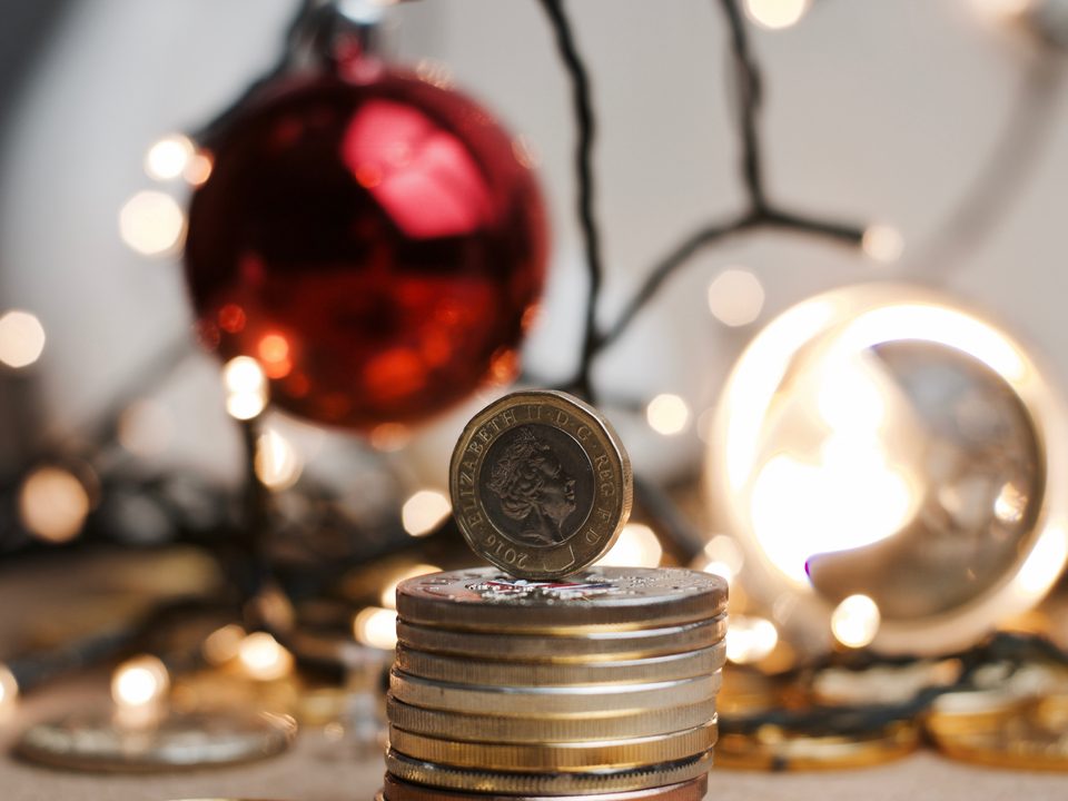 a pile of cash with jewellery in the background