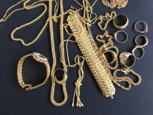 Gold jewellery on a dark background