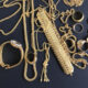 Gold jewellery on a dark background