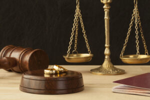 Weighing scales with two gold rings in the foreground. Sell jewellery for cash.