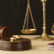 Weighing scales with two gold rings in the foreground. Sell jewellery for cash.