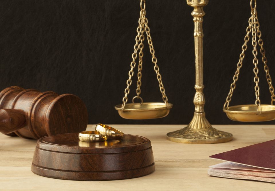 Weighing scales with two gold rings in the foreground. Sell jewellery for cash.