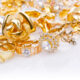 Selection of expensive gold jewellery on a white table