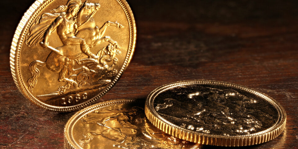 Three krugerrand coins on a table