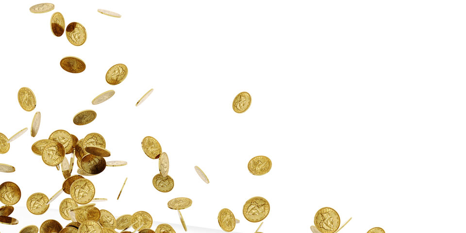 A pile of old gold coins falling on to a white surface