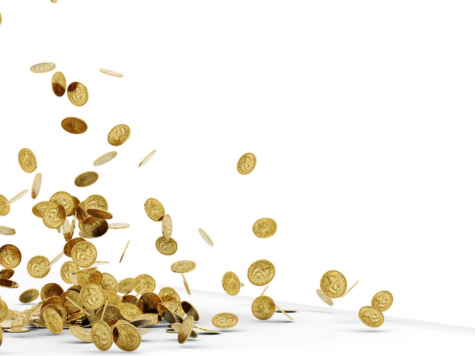 A pile of old gold coins falling on to a white surface