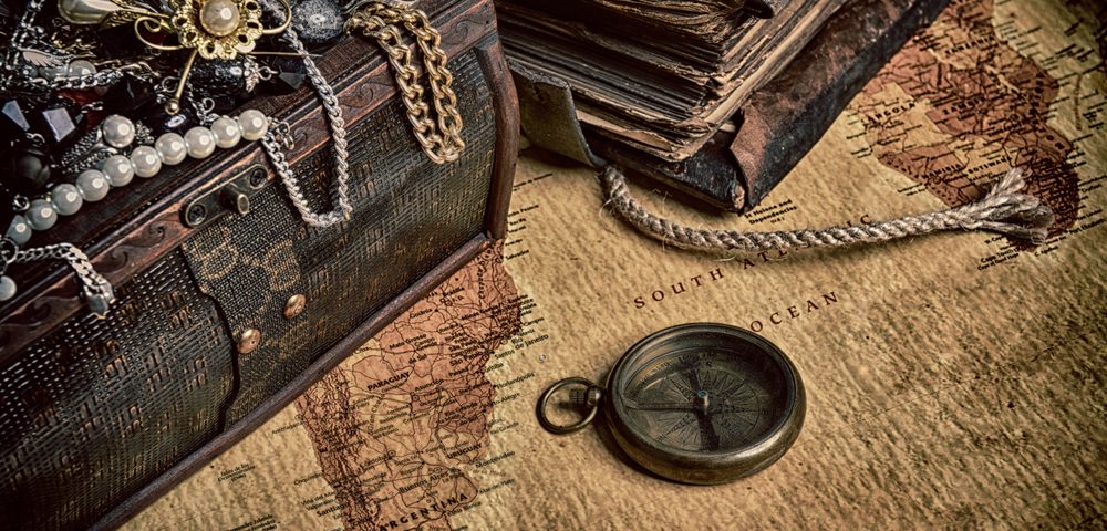 Selection of antique jewellery draped over a antique chest