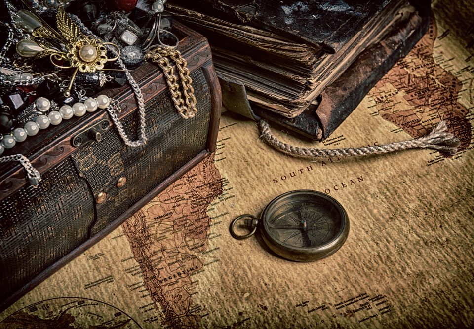 Selection of antique jewellery draped over a antique chest